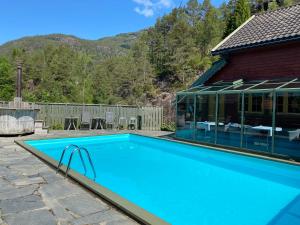 a swimming pool in front of a house at Mo Laksegard in Sand