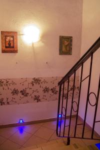 a staircase with a light and a wall with a flower pattern at Pokoje Gościnne in Kołobrzeg