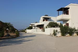 a white house with a driveway in front of it at Galini in Agia Irini Milos