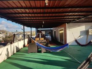 a hammock on the balcony of a house at Hostal Cattleya in Puerto Baquerizo Moreno