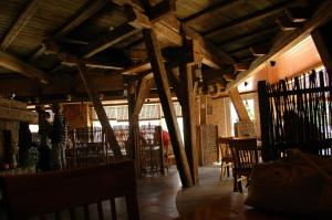 a room with wooden ceilings and tables and chairs at Cafe Hotel Rudzons in Madona