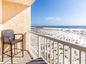 a balcony with a chair and the beach at Islander Condominiums I in Fort Walton Beach