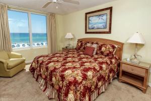 a bedroom with a bed and a window with the ocean at Island Princess Condos in Fort Walton Beach