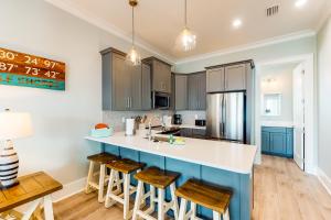 une cuisine avec des placards bleus et un comptoir blanc dans l'établissement West Side Cottage #MM, à Gulf Shores