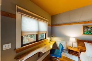 a bedroom with a bed and a desk and a window at Tacoma's Sweet Suite in Tacoma