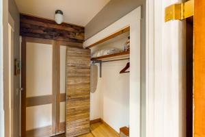 a closet with a wooden door in a room at Tacoma's Sweet Suite in Tacoma