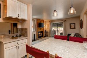a kitchen and dining room with a table and red chairs at Red Pine in Park City