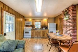 a kitchen with a table and a refrigerator at Swallow Falls Cabin #2 in Oakland