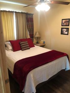 a bedroom with a large bed with red pillows at Alpaca Inn in Lava Hot Springs
