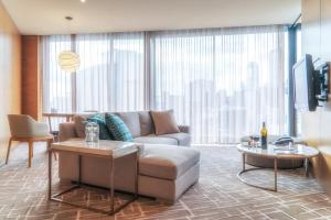 
a living room filled with furniture and a window at Pan Pacific Melbourne in Melbourne

