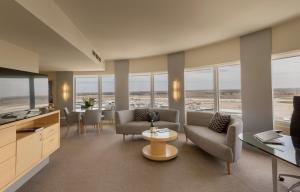 a living room with a view of an airport at PARKROYAL Melbourne Airport in Melbourne