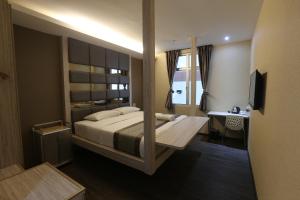 a bedroom with a large bed and a window at Kota Heritage Hotel in Kota Tinggi +53 photos