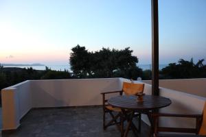 a table and chairs on a balcony with a view at Galini in Agia Irini Milos