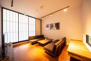 a living room with a couch and a table at ENGAWA Nakano in Tokyo