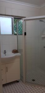 a bathroom with a shower, sink, and toilet at Mango Tree Motel in Agnes Water