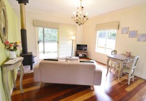 a living room with a couch and a table at Apple Tree Cottage Montville in Montville