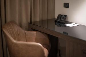a desk with a chair and a laptop on it at Duxton Hotel Perth in Perth