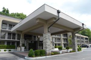 a large building with awning in a parking lot at Baymont by Wyndham Nashville Airport in Nashville