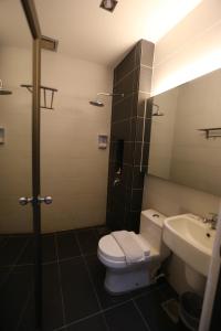 a bathroom with a toilet and a sink at Kota Heritage Hotel in Kota Tinggi