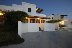 a large white house with a night view of it at Galini in Agia Irini Milos