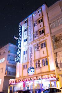 a building with a sign on the side of it at Exporoyal Hotel in Antalya