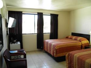 a hotel room with two beds and a window at #35 Bungalow Seaside Hotel & Victors RV Park in San Felipe