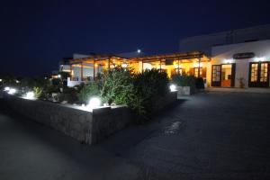 a building with lights in front of it at night at Galini in Agia Irini Milos