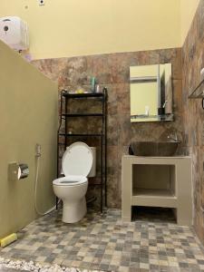 a bathroom with a toilet and a sink at Embay House & Private Pool in Bogor