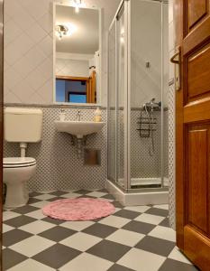 a bathroom with a toilet and a sink and a shower at Apartment Lapov in Ičići
