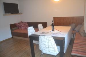 a room with a table and chairs and a couch at Apartments EMMA, Zillertal, Tirol in Kaltenbach