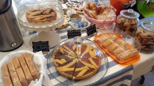 a table with various pastries and other foods on it at Villa Bruna in Cesenatico