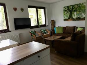 a living room with a couch and a table at Apartman Kristof in Vysoke Tatry - Tatranska Lomnica.