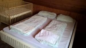 two beds with white blankets and pillows on them at Rustic Country House in Snagov in Snagov