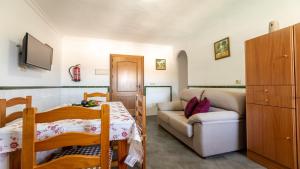 Habitación pequeña con cama y sofá en Apartamento Luz C, en Bolonia