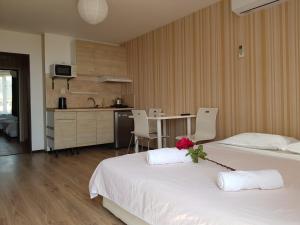 a hotel room with two beds and a kitchen at Sunny Island Obzor in Obzor