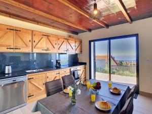 a kitchen with a table and a dining room at Casa da Felicidade by LovelyStay in Prazeres