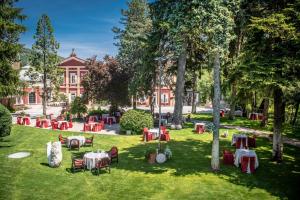 a grassy area with a large lawn and a fire hydrant at Hotel Villa Madruzzo in Trento