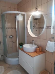 a bathroom with a sink and a shower and a mirror at Apartment Čiovo Radić in Trogir +50 photos