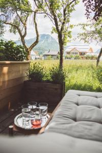 a tray with glasses on a table in a field at Luxus Ferienhaus Altaussee in Puchen