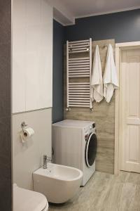 a bathroom with a washing machine and a sink at Sopot, BIG APARTMENT FOR 6!!! Air condition, jacuzzi in Sopot +18 photos