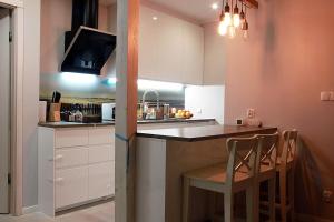 a kitchen with white cabinets and a counter top at Sopot, BIG APARTMENT FOR 6!!! Air condition, jacuzzi in Sopot