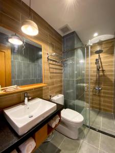 a bathroom with a sink and a toilet and a shower at Coast House Boutique Hotel in Nha Trang