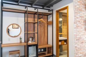 a bathroom with a glass door and a brick wall at Coast House Boutique Hotel in Nha Trang
