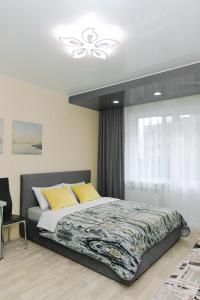 a bedroom with a large bed and a window at Central Apartment near by Marriott hotel in Novosibirsk