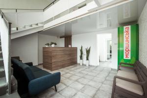 a lobby with a couch and a reception desk at REEF Hotel in Koblevo