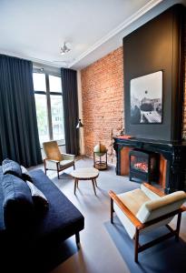 a living room with a couch and a fireplace at V Lofts in Amsterdam