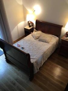a bed in a bedroom with two night stands and two lamps at Casa AURORA in Amarante