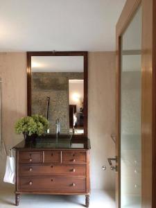 a dresser with a mirror on top of it at Casa AURORA in Amarante