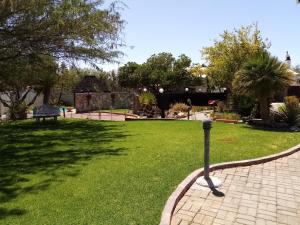 a park with a pole in the grass at Daisy Country Lodge in Springbok