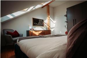 a bedroom with a large bed and a chair at Luxury Oasis, Sauna, AC and Free Parking in Brno